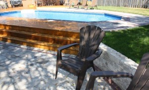 onground pool in backyard reduces need for seperate retaining wall
