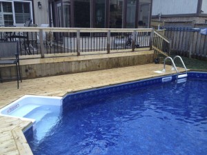 Pool with built in retaining wall